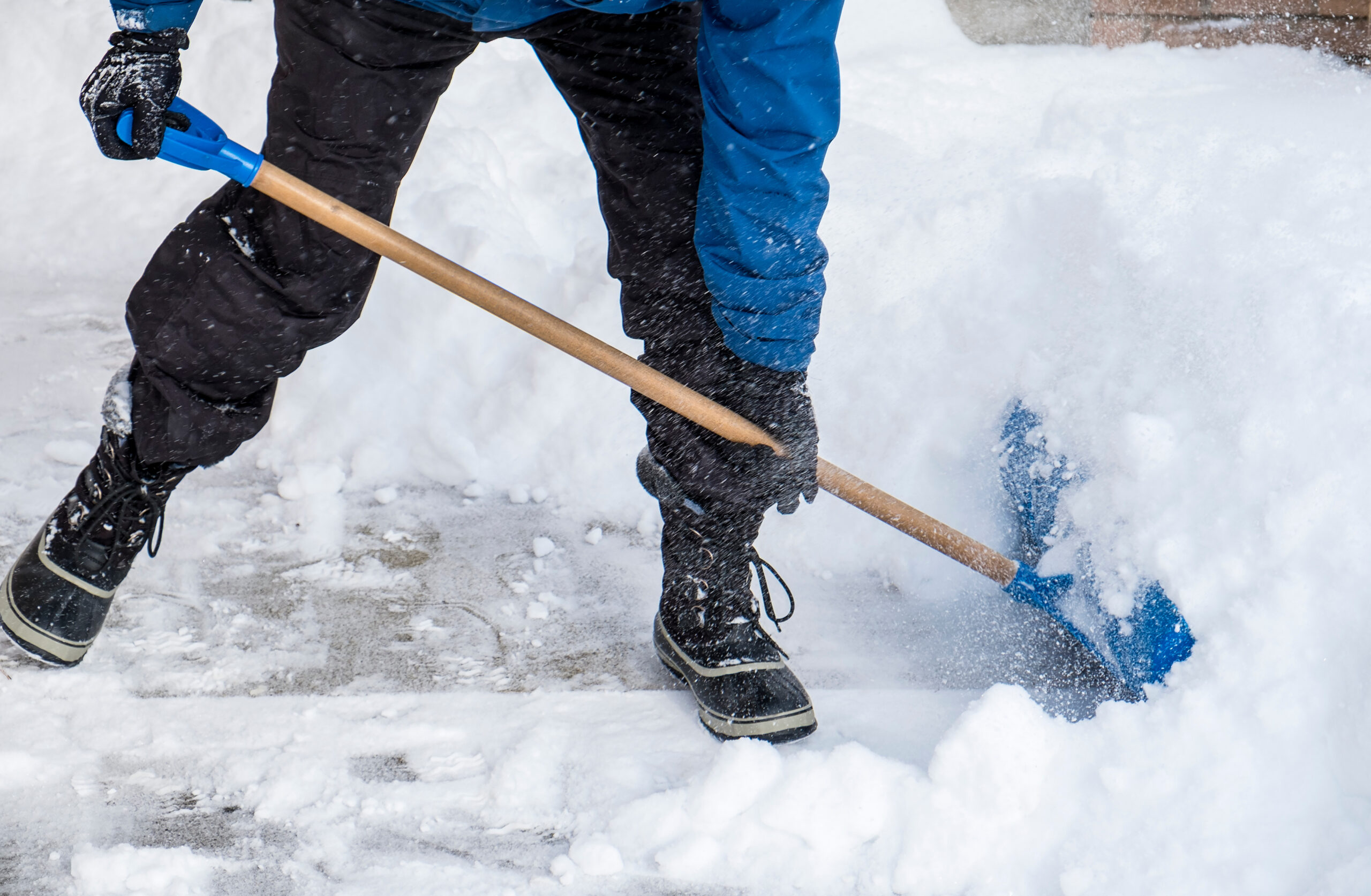 Man Removing Snow from His Driveway